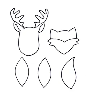 A white page printout with black outline of reindeer and fox heads at the top with two owl wings and a fox tail below.