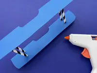 The lower and upper wing of the plane glued together in parallel by two straws, cut down to the desired height.