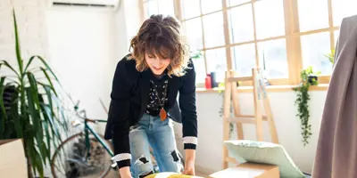 Woman unpacking a cardboard box during a house decluttering