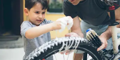 Father and son cleaning a bicycle