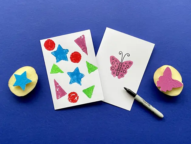 Potato printed red hearts on white paper