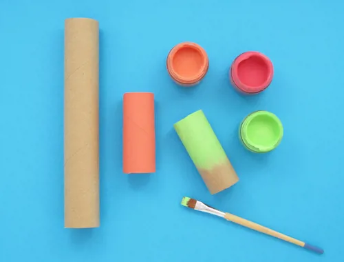 Two cardboard tubes painted and left to dry.