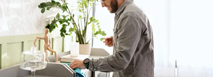 Man in grey shirt deep cleans his home.